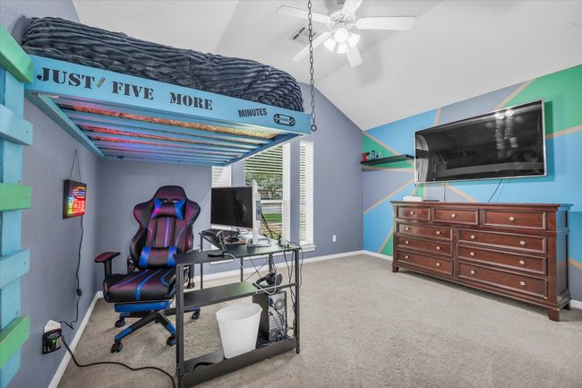 Carpeted office with baseboards, lofted ceiling, and ceiling fan | Image 23