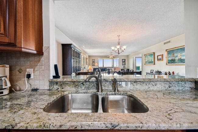 Wall was opened to expand the view from the kitchen. | Image 16