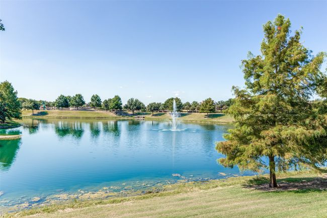 Community lake with water feature and walking path adjacent to much of it. | Image 25