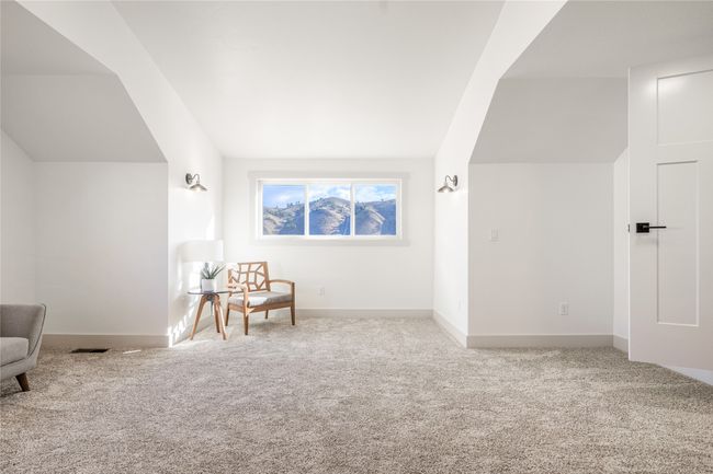 Sitting room with carpet floors and lofted ceiling | Image 29
