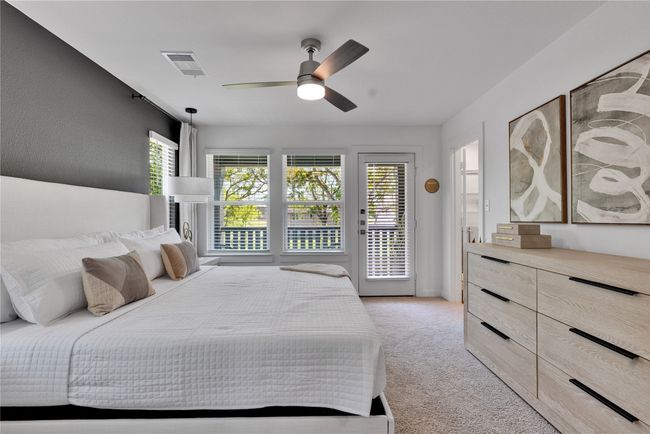 Bedroom with light carpet, access to outside, ceiling fan, and visible vents | Image 19