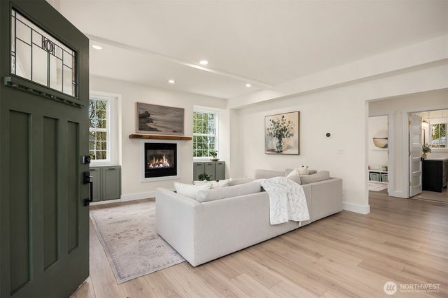 Enter into the grand, open living room complete with built-in storage and a gas fireplace. | Image 4