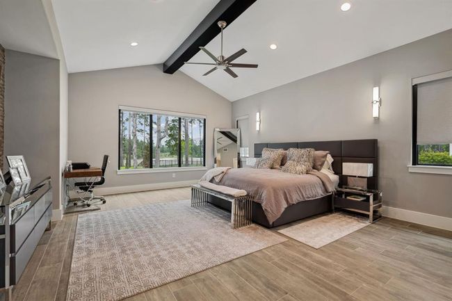 Expansive primary suite featuring large windows that showcase breathtaking views, with remote-controlled blinds for effortless convenience. | Image 26