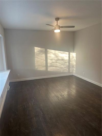 Spare room with ceiling fan and dark hardwood / wood-style floors | Image 3