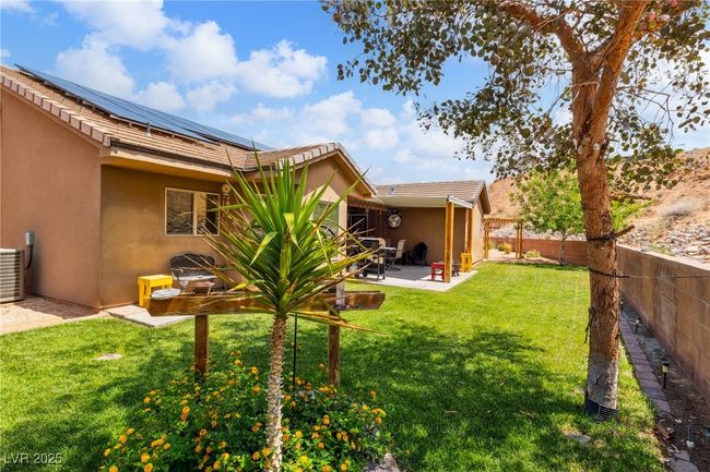 View of yard featuring a patio area and central air condition unit | Image 38