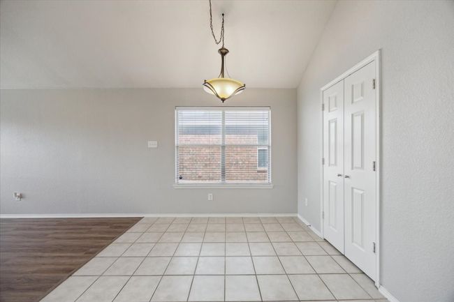 Unfurnished dining area with vaulted ceiling and baseboards | Image 6