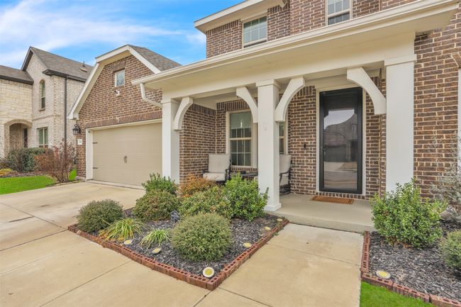 View of exterior entry featuring a garage and a porch | Image 4