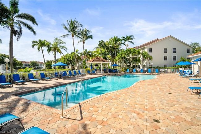Pool featuring a gazebo, fence, and a patio area | Image 38