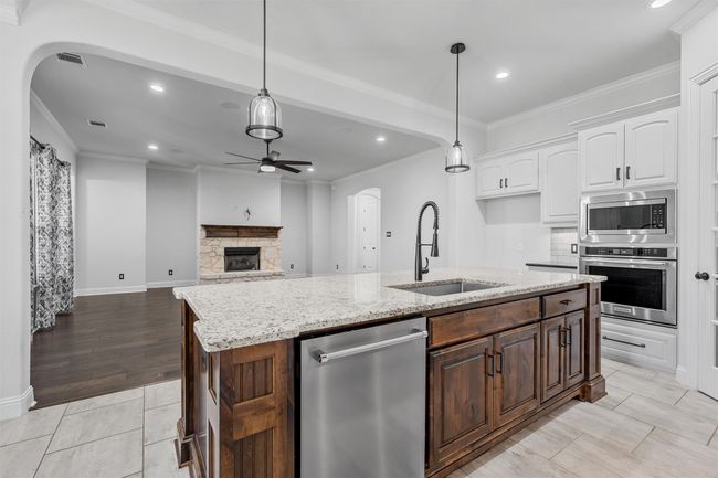 Kitchen with appliances with stainless steel finishes, a ceiling fan, recessed lighting, arched walkways, and ornamental molding | Image 12