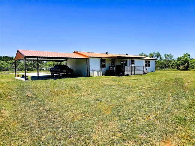 Rear view of property with a carport and central air condition unit | Image 28