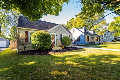 View of front facade featuring a garage, a front yard, and an outbuilding | Image 3