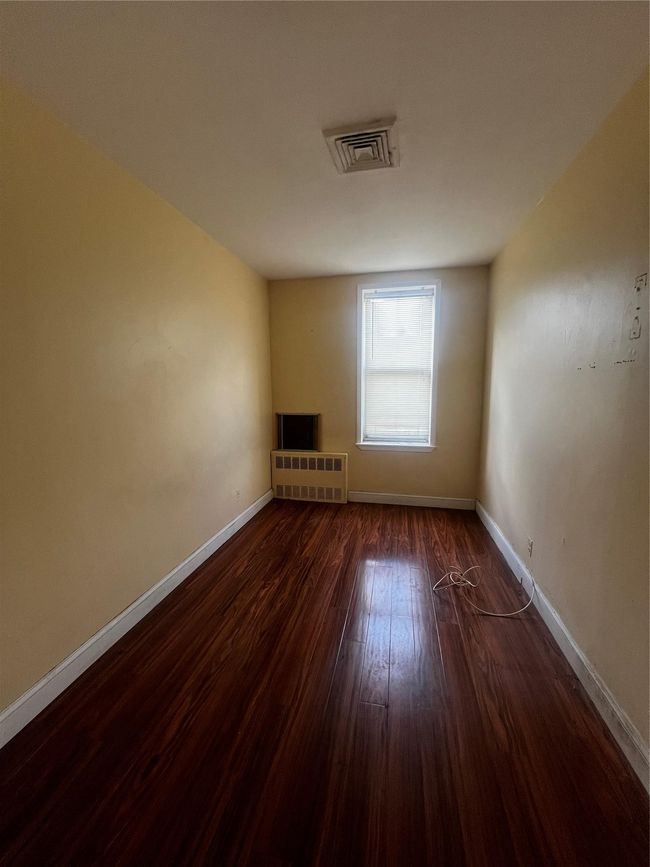 Empty room with wood finished floors and baseboards | Image 4