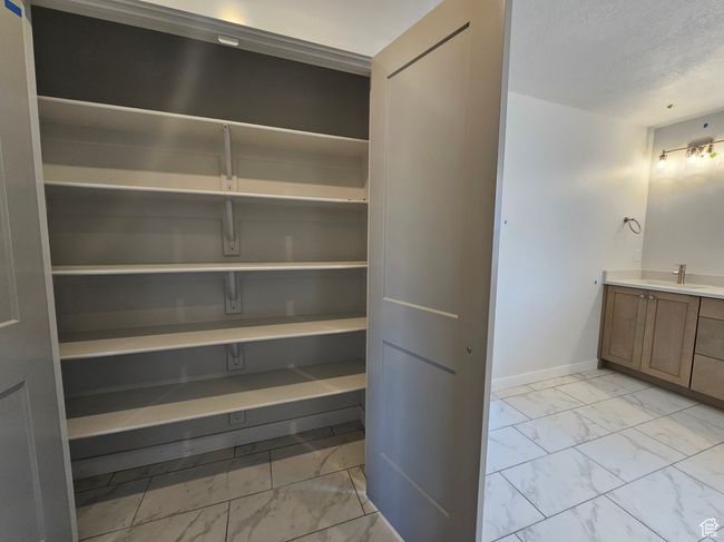 Storage area featuring a sink | Image 22