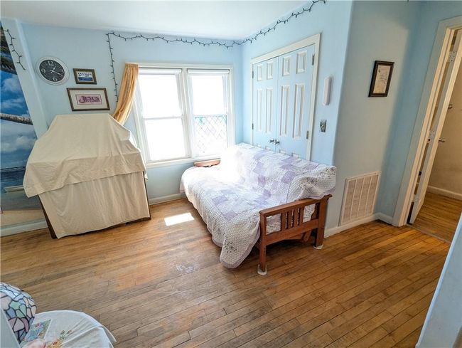 Bedroom with baseboards, visible vents, a closet, and wood-type flooring | Image 28