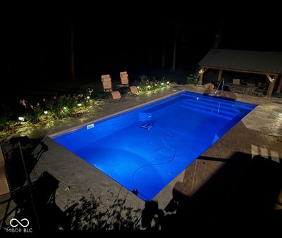 Experience luxury under the stars with this heated 13x30 pool, gently sloping from 3 to 5 feet-perfect for evening swims | Image 3