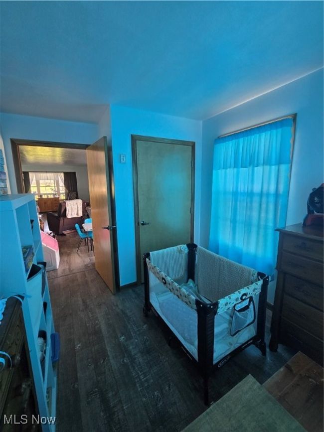 Bedroom featuring wood finished floors and a closet | Image 40