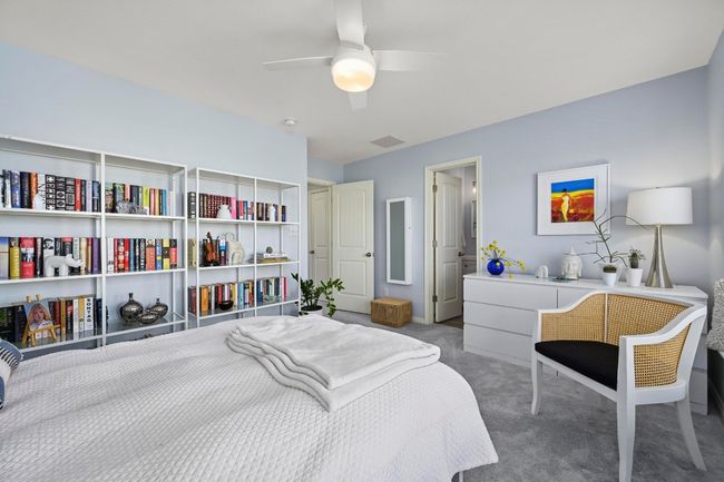 Bedroom featuring a ceiling fan, carpet flooring, and visible vents | Image 31