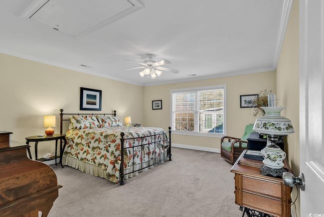 Carpeted bedroom with crown molding, ceiling fan, and a tray ceiling | Image 30