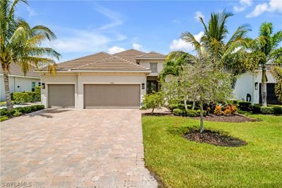 View of front of property with a garage and a front lawn | Image 2