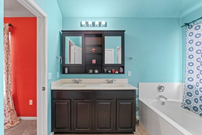 Bathroom featuring double vanity, a garden tub, and a sink | Image 9