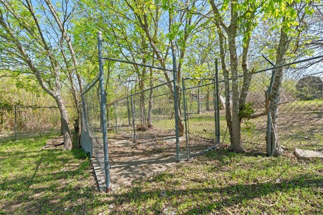 Former dog run in the fenced area inside the larger yard. | Image 9