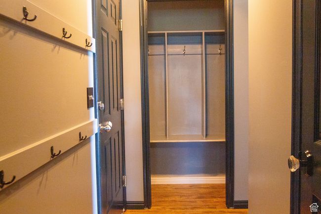 Entry from garage with closet/mud room area, with wood finished floors | Image 21