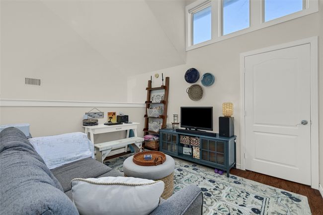 Living area featuring wood finished floors and high vaulted ceiling | Image 14
