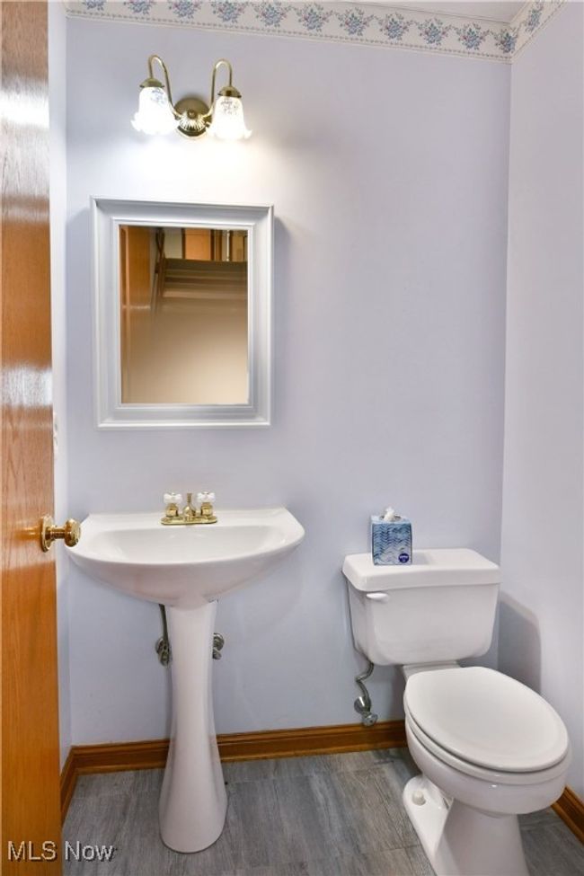 Bathroom with baseboards and wood finished floors | Image 20