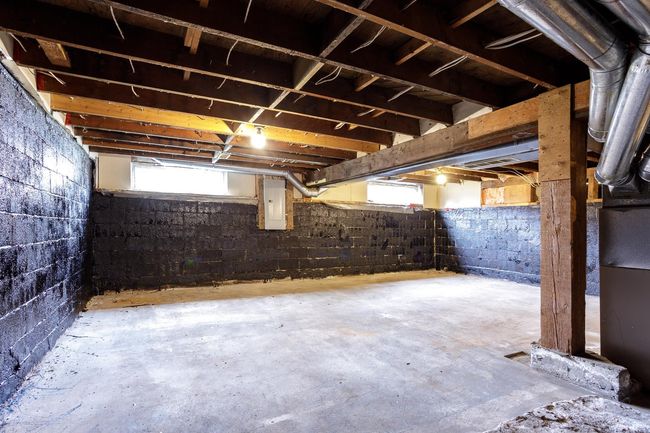 Below grade area featuring electric panel and a wealth of natural light | Image 33