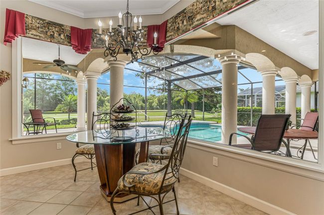 Dinette with Oversized Picture Windows Overlooking Gorgeous Pool and Screened Lanai | Image 15
