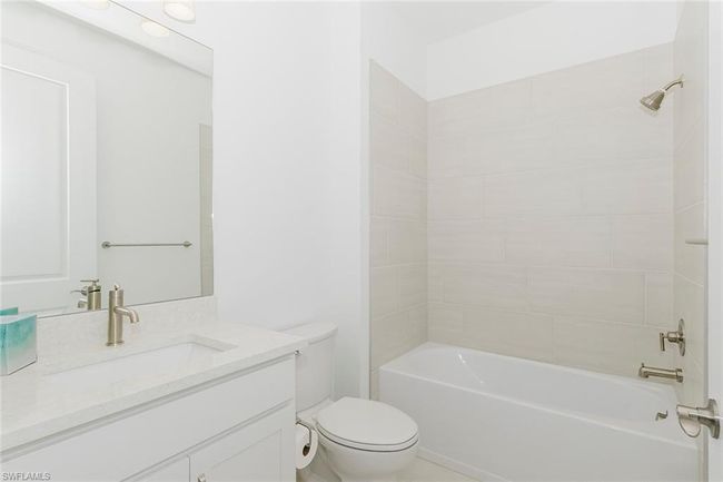 Bathroom with vanity and bathtub / shower combination | Image 6
