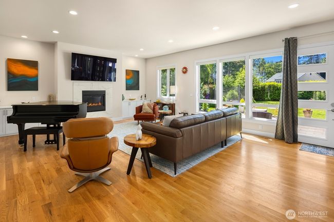 The open floor plan has plenty of space for all the features of your modern life. Cozy gas fireplace, built-in cabinets, and feature walls for your art collection. | Image 4