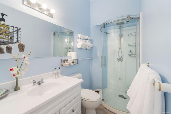 Full bathroom featuring a stall shower, toilet, and vanity | Image 36