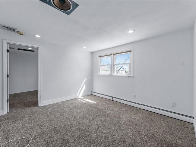 Spare room featuring baseboard heating, carpet floors, recessed lighting, and baseboards | Image 22