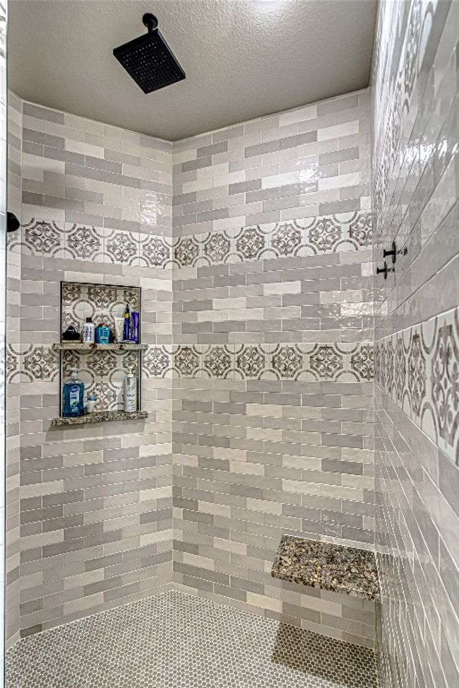 Full bath featuring a custom floor to ceiling tile shower w/ rain shower head | Image 27