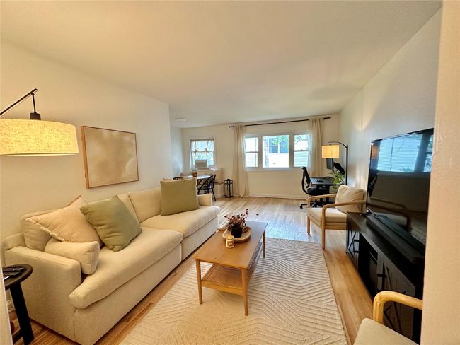 Living room featuring light wood-style flooring | Image 5