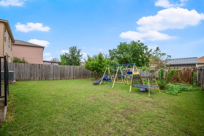 Fenced backyard with a playground | Image 22