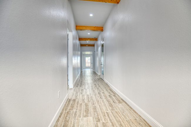 Corridor featuring beamed ceiling and light hardwood / wood-style floors | Image 11