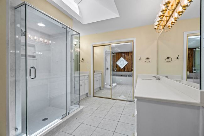 Bathroom featuring vanity, a stall shower, tile patterned floors, and a chandelier | Image 14