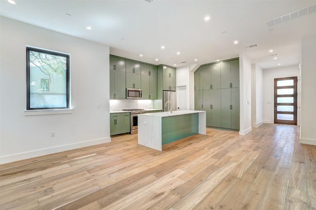 Kitchen featuring green cabinetry, stainless steel appliances, healthy amount of natural light, and recessed lighting | Image 24