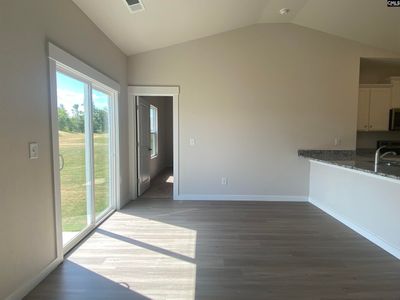 Located off the kitchen, the dining nook showcases luxury vinyl plank flooring and a large window. | Image 3