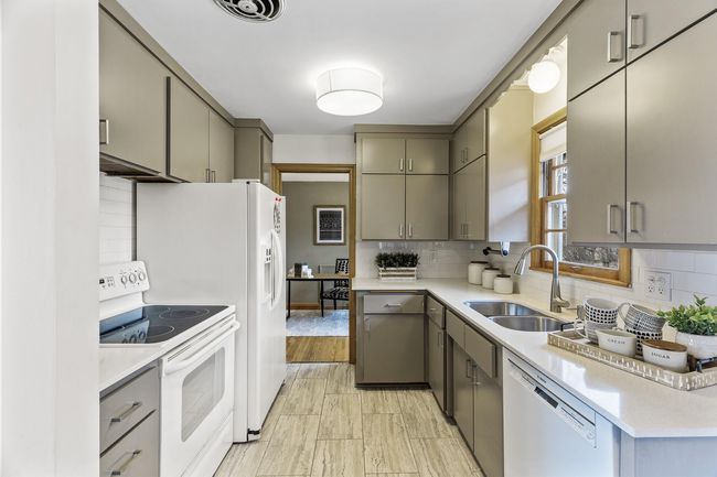 Nice silestone countertops, kitchen window, and ample cabinet space | Image 13