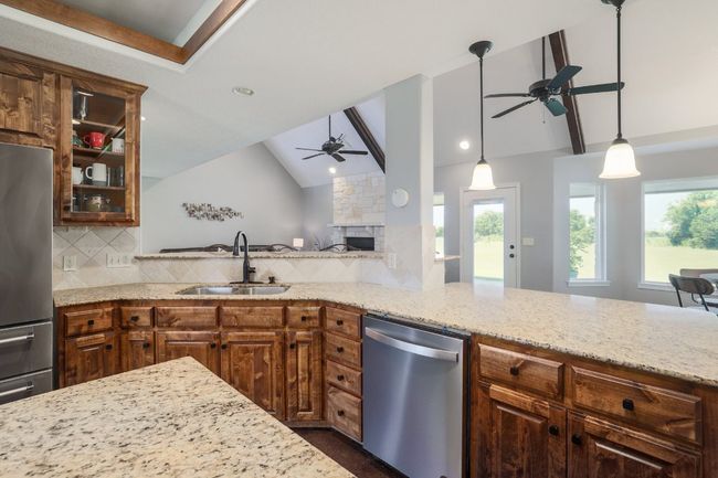 Kitchen open to living room, breakfast area and second living area with great view of backyard. | Image 13
