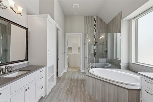 En suite master bathroom with separate shower and garden tub, plus walk-in closet | Image 21
