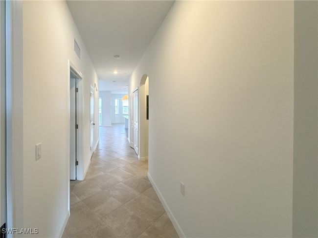Corridor featuring baseboards and arched walkways | Image 32