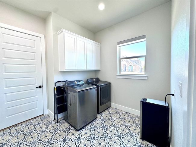 Washroom featuring washing machine and dryer, cabinet space, and light flooring | Image 28