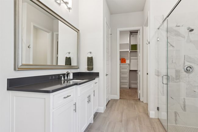 Bathroom featuring a shower stall, vanity, and a spacious closet | Image 19