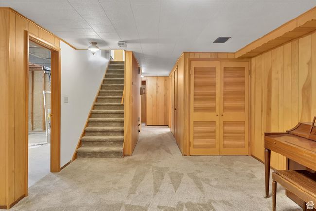 Stairway featuring carpet floors and wood walls | Image 22