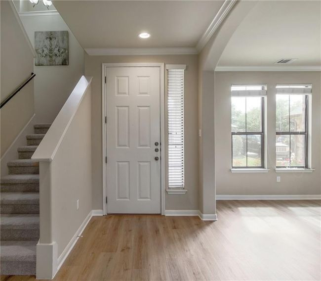 Foyer featuring light wood-type flooring, crown molding, stairs, recessed lighting, and arched walkways | Image 14