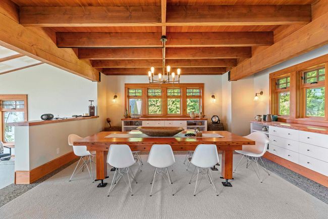 Dining space featuring wooden ceiling with exposed beams, a chandelier, and baseboards | Image 13